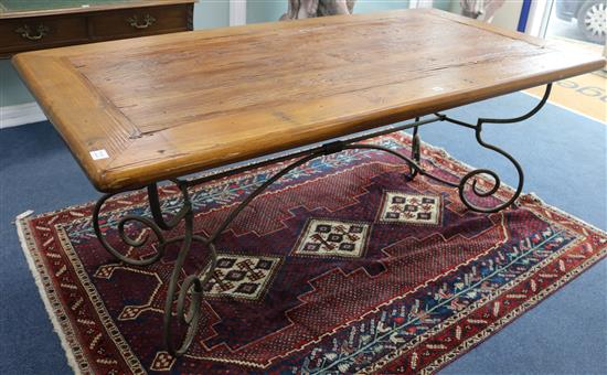 An Oak refectory table with wrought iron base, W.198cm